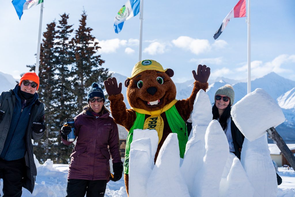 snow sculpture with people waving